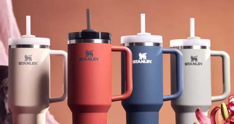 Four Stanley water bottles in various colors and sizes, representing hydration solutions