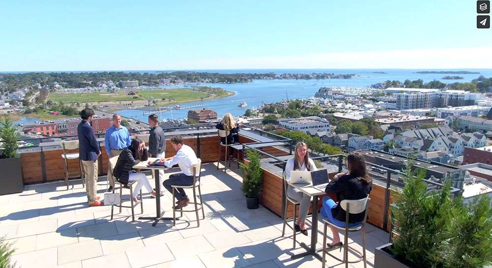 Team members working on the rooftop of SONO50, showcasing a collaborative outdoor workspace