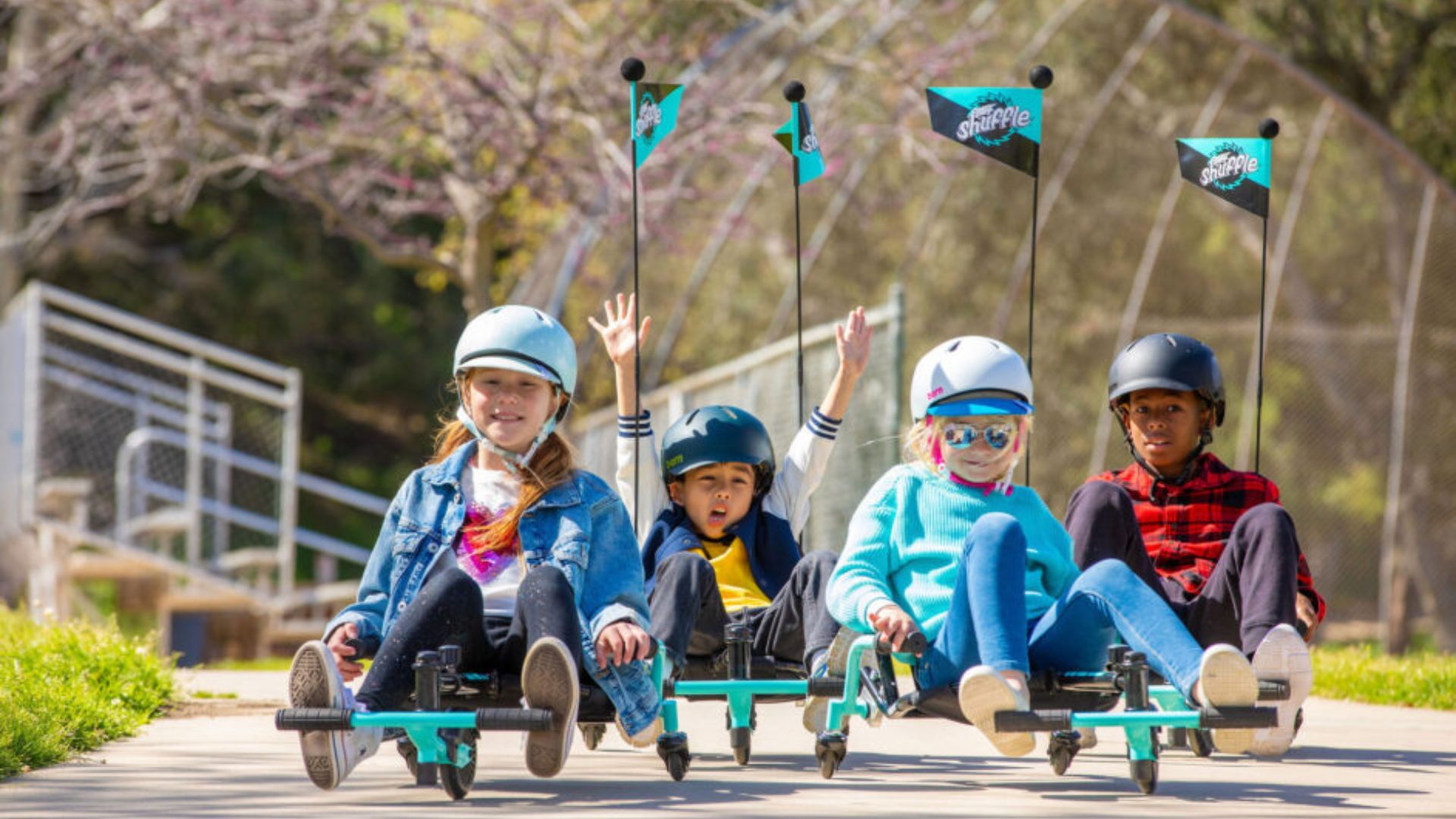 Kids enjoying the Razor Crazy Cart Shuffle with 360-degree spins